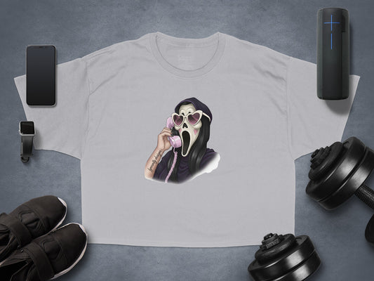Graphic t-shirt with ghost face holding heart sunglasses and phone.