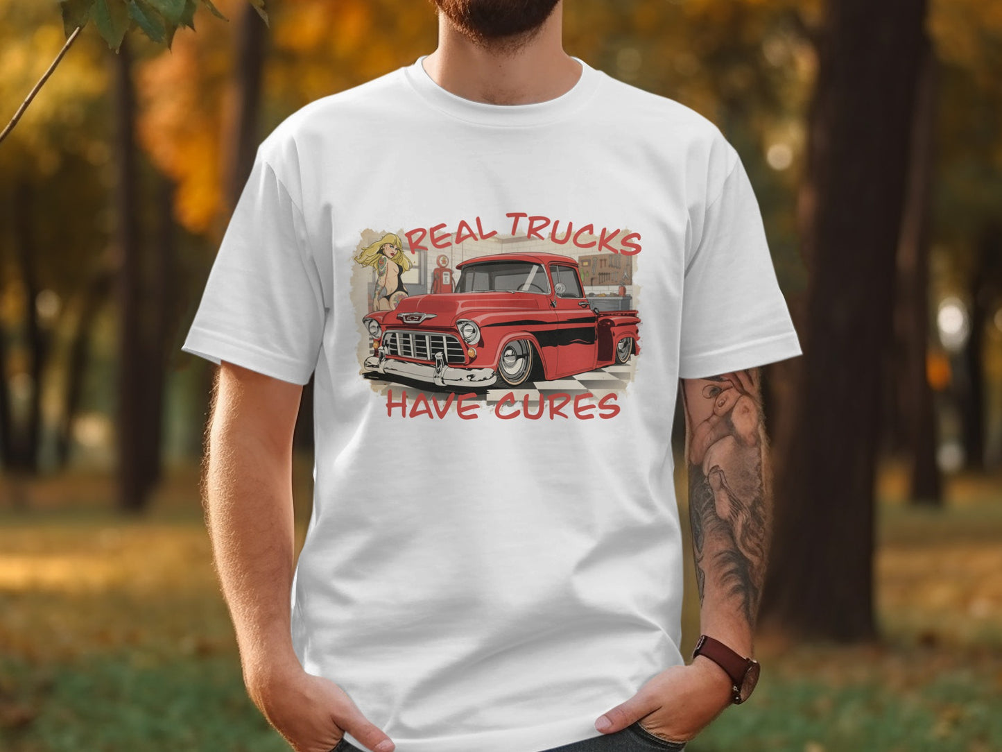 White t-shirt with red vintage truck and text "REAL TRUCKS HAVE CURES".