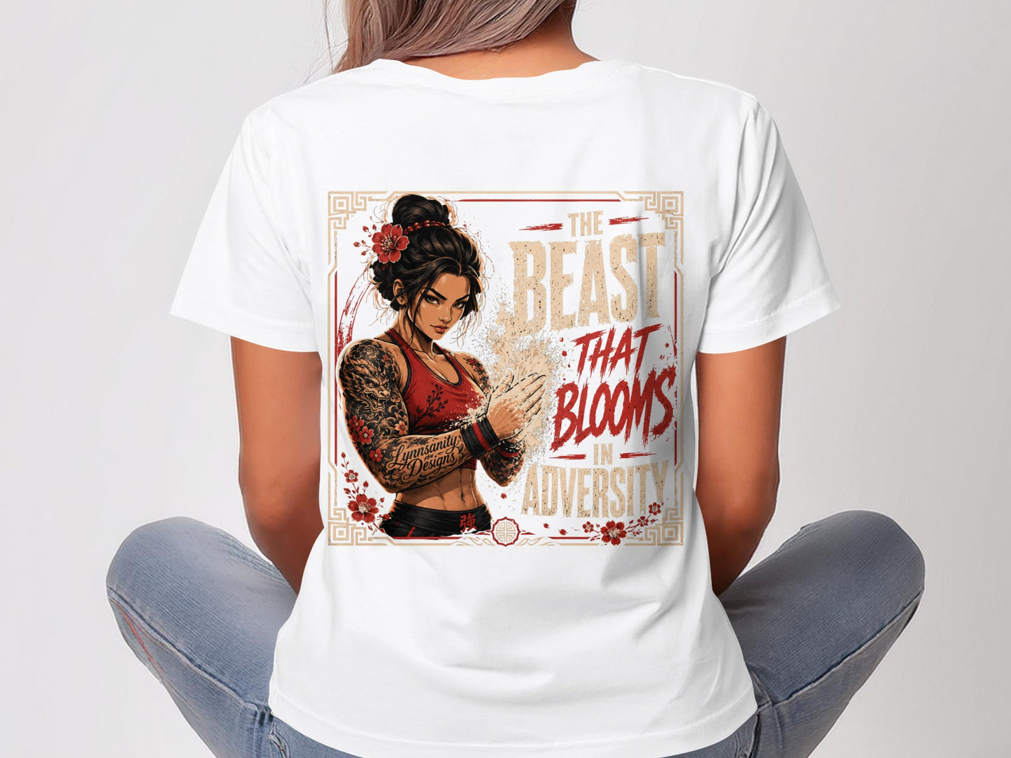 Woman wearing a white t-shirt with a "The Beast That Blooms In Adversity" graphic.