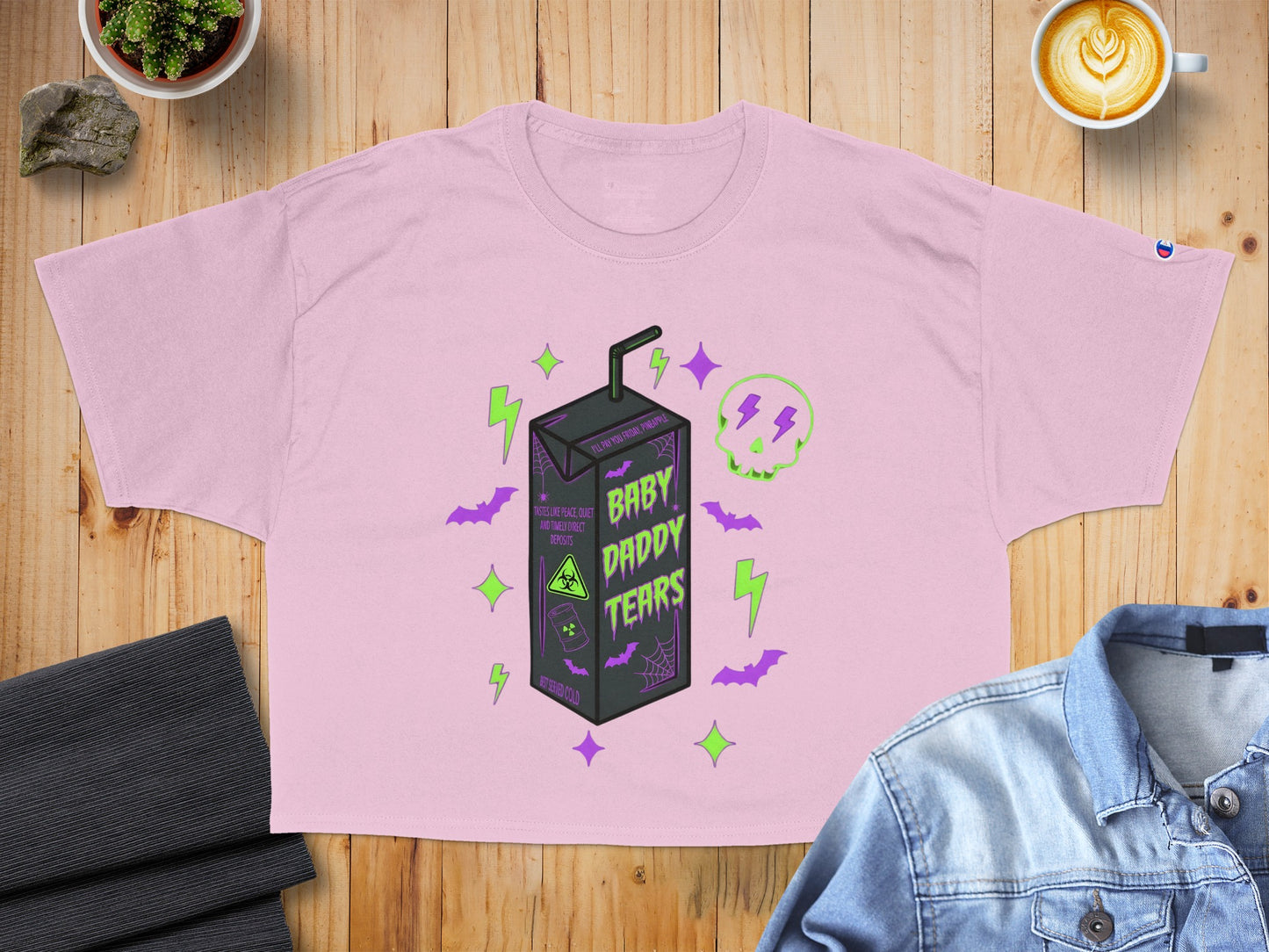 Pink graphic crop top with "Baby Daddy Tears" text and juice box design.