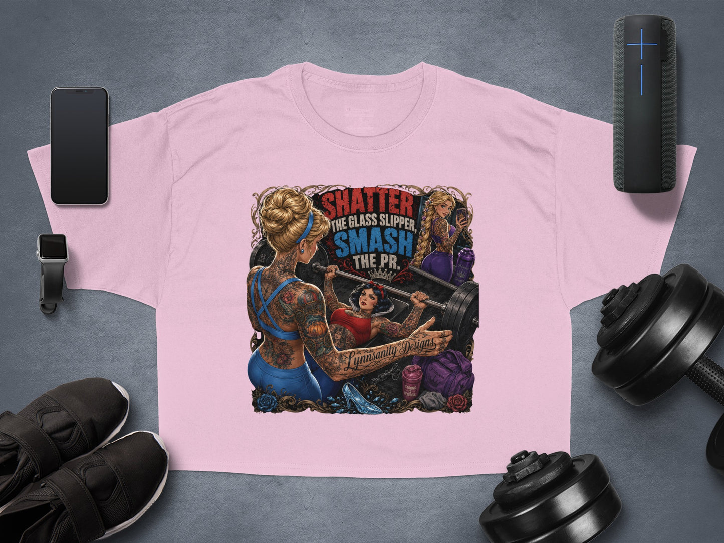 Pink cropped t-shirt with "Shatter the glass slipper, smash the PR" slogan and barbell graphic.