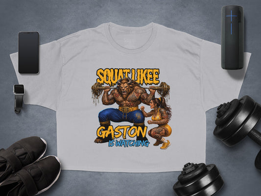 Grey t-shirt with Gaston character lifting weights, text reads "SQUAT LIKE GASTON IS WATCHING."