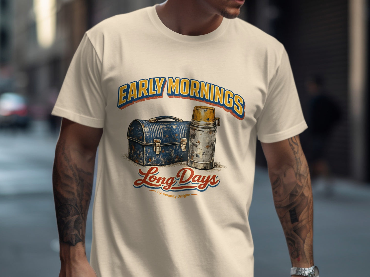 Cream t-shirt with "Early Mornings Long Days" text and retro lunchbox graphic.