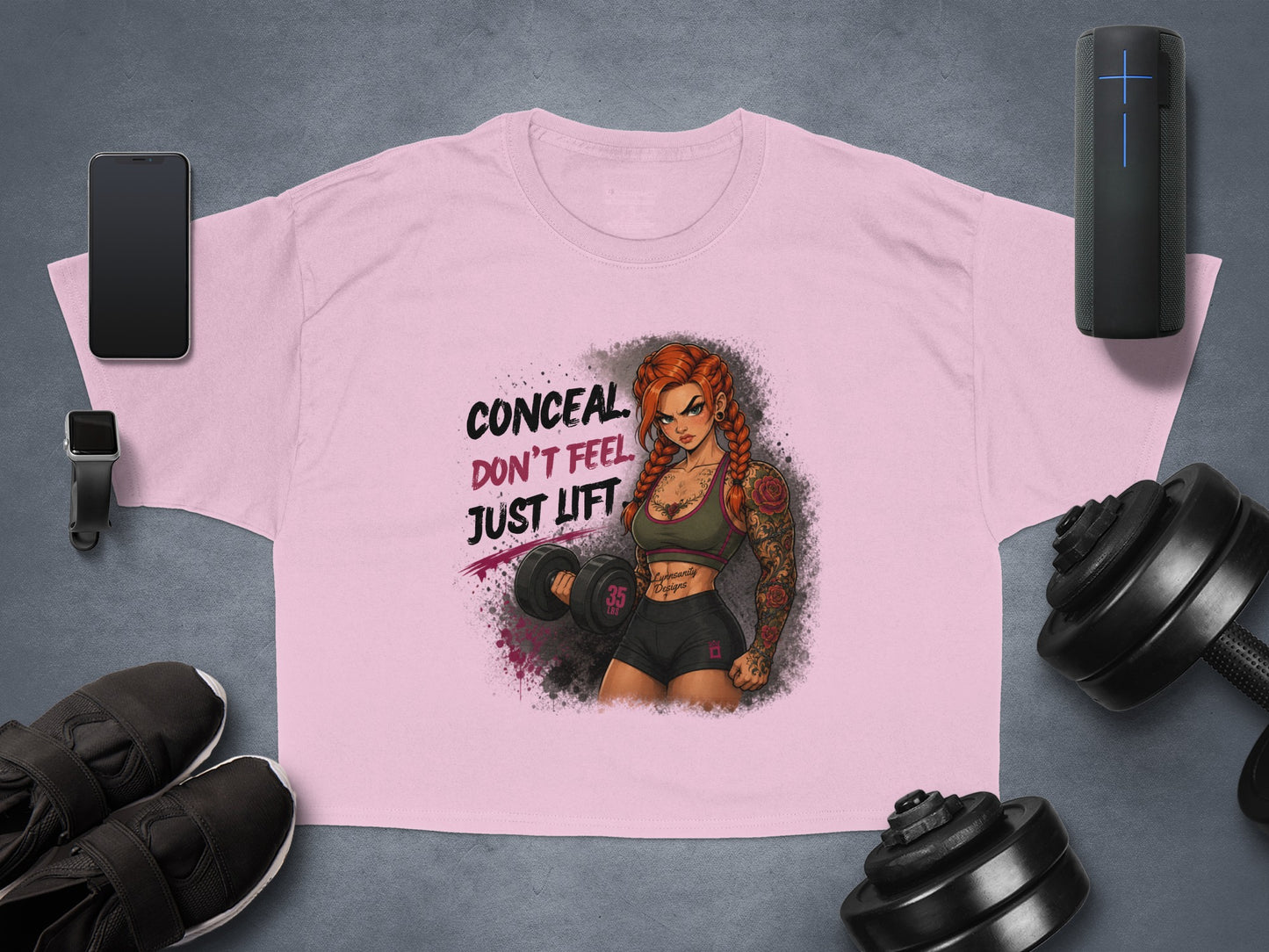 Pink t-shirt with graphic of tattooed woman and text "CONCEAL DON'T FEEL JUST LIFT".