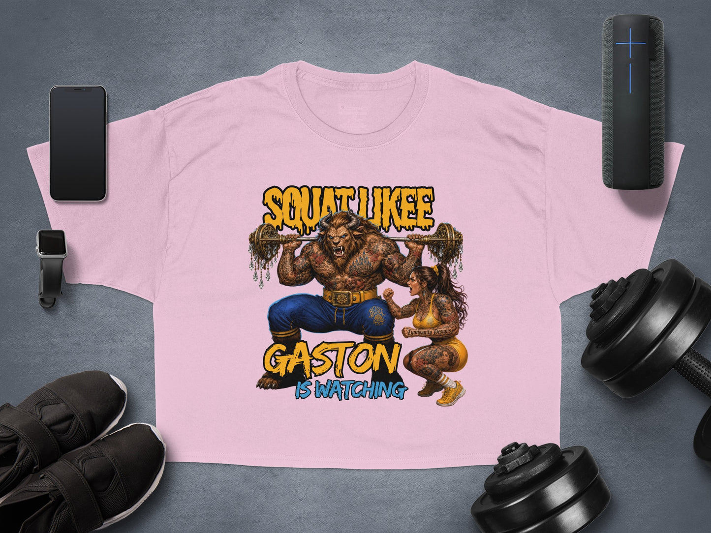 Pink t-shirt with "Squat Likee Gaston Is Watching" text and cartoon characters.