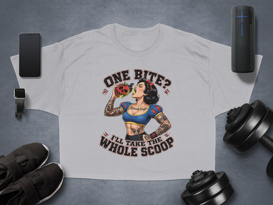 Woman with apple tattoo eating apple, text "ONE BITE? I'LL TAKE THE WHOLE SCOOP".