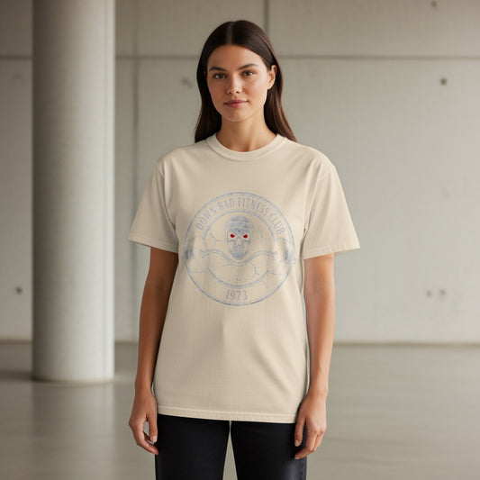 Cream t-shirt with distressed "DOWN BAD FITNESS CLUB 1973" circular graphic.