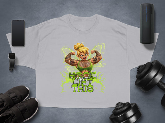 Tinkerbell with tattoos flexing on a grey t-shirt with text.