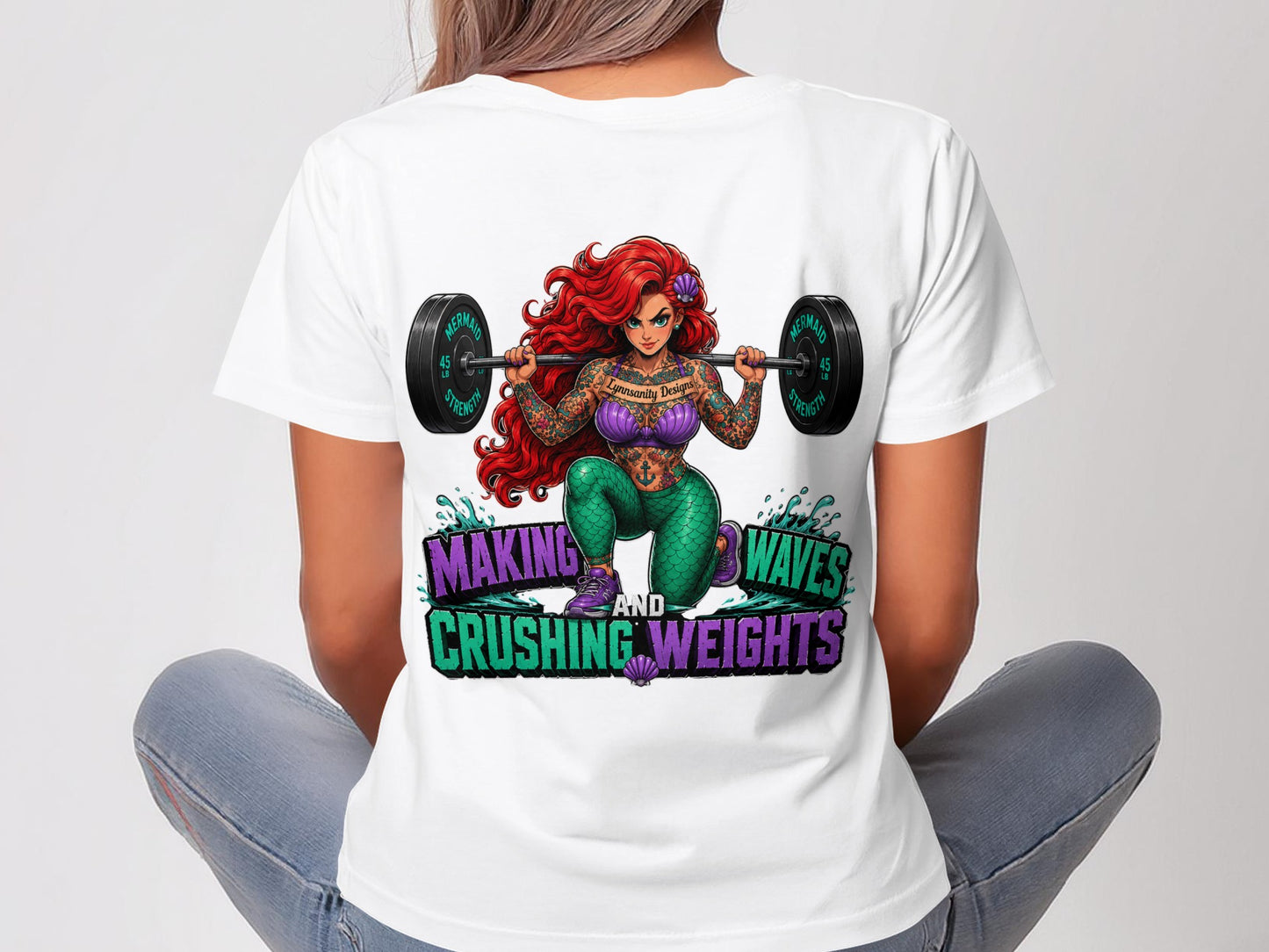 T-shirt graphic of Ariel lifting weights with "Making Waves and Crushing Weights" text.
