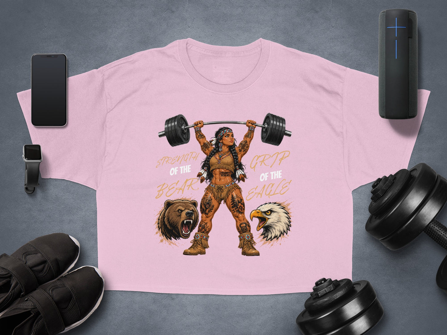 Pink t-shirt with woman lifting barbell, bear and eagle graphics.