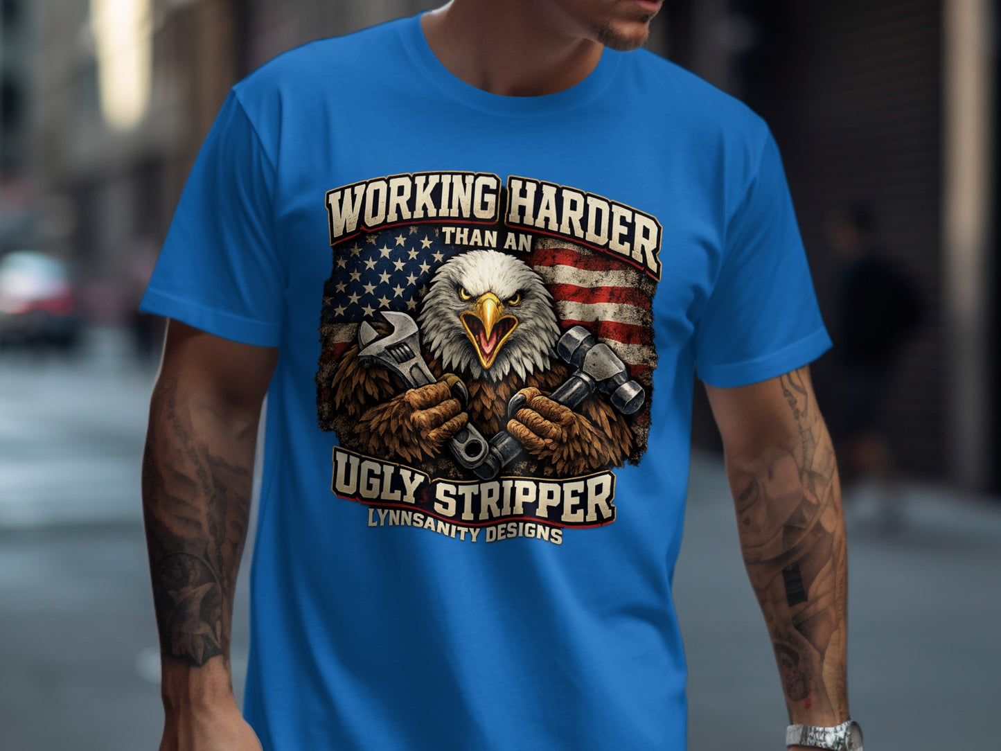 Blue t-shirt with eagle holding wrenches, "Working Harder" text, and flag.