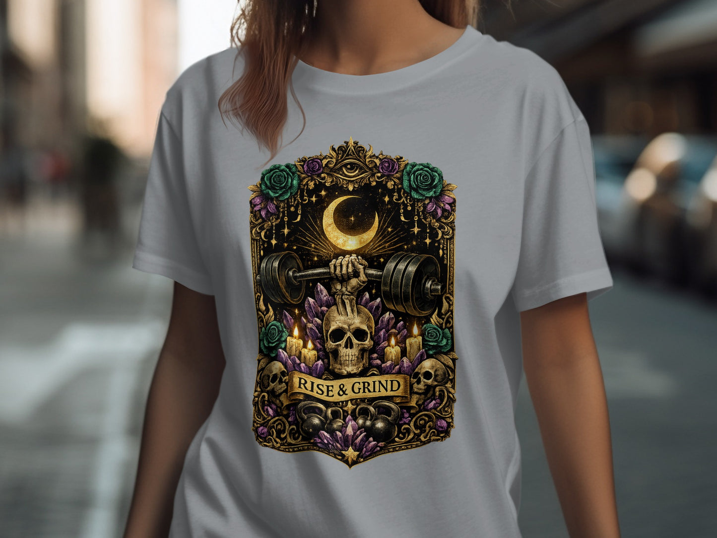T-shirt with skull holding dumbbell, moon, stars, and "RISE & GRIND" text.