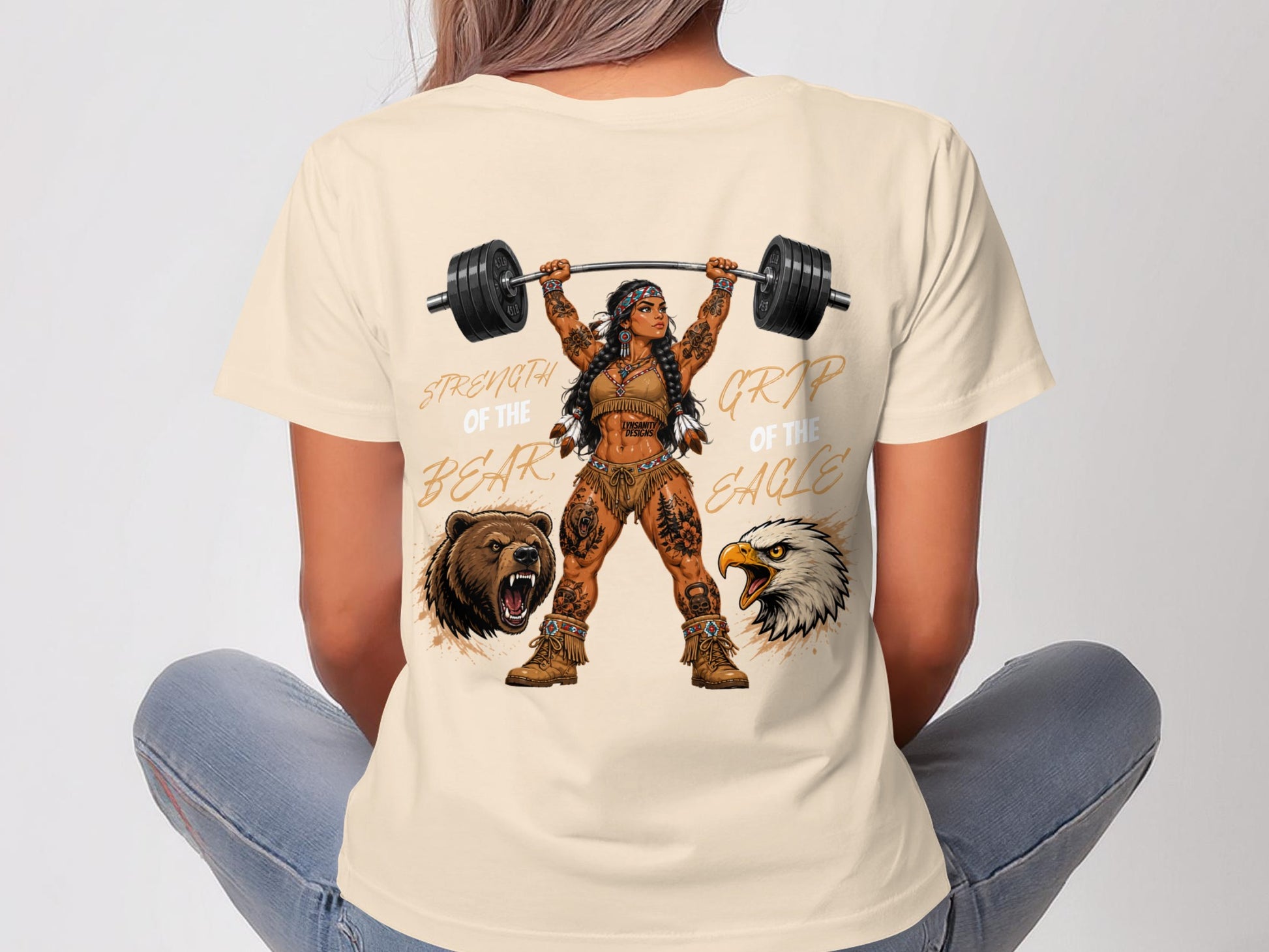 Woman in t-shirt lifting barbell with bear and eagle graphics, text "STRENGTH OF THE BEAR GRIP OF THE EAGLE".