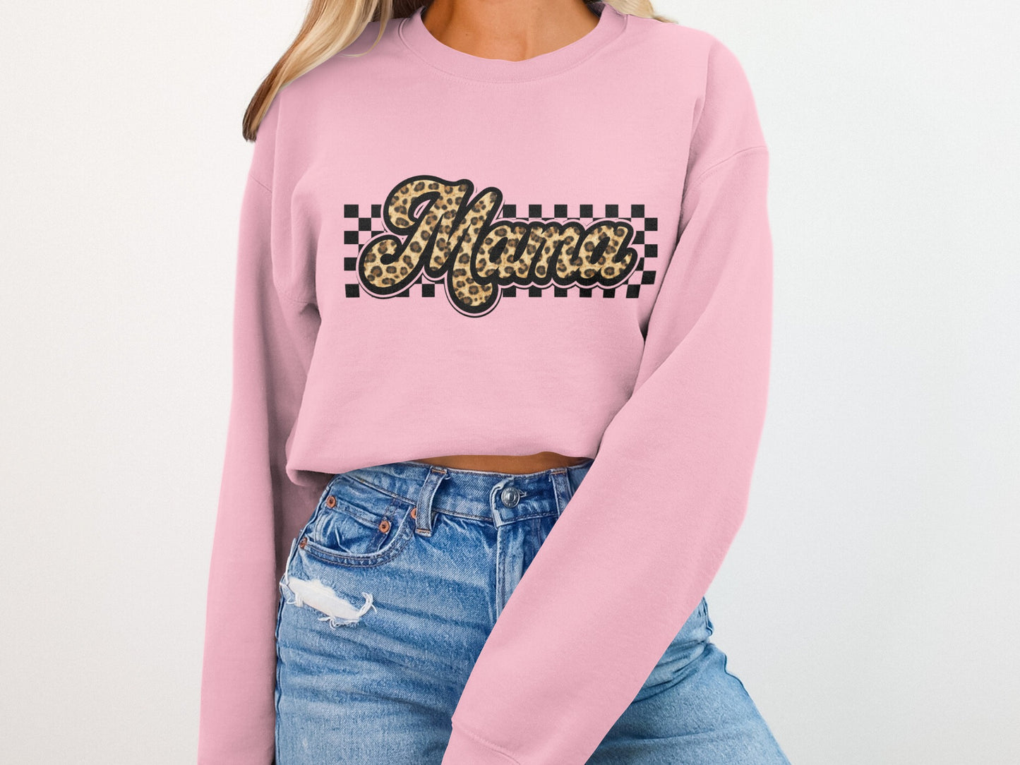 Pink crewneck sweatshirt with "Mama" in leopard print and checkered pattern.