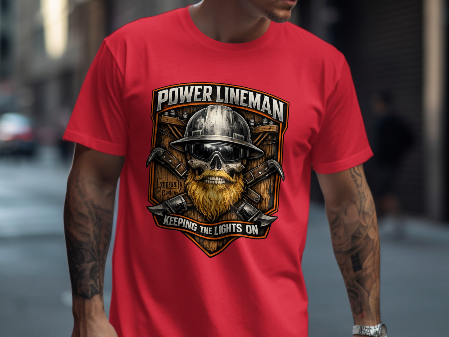 Power Lineman text with crossed hammers, hard hat, and beard graphic on a red t-shirt.