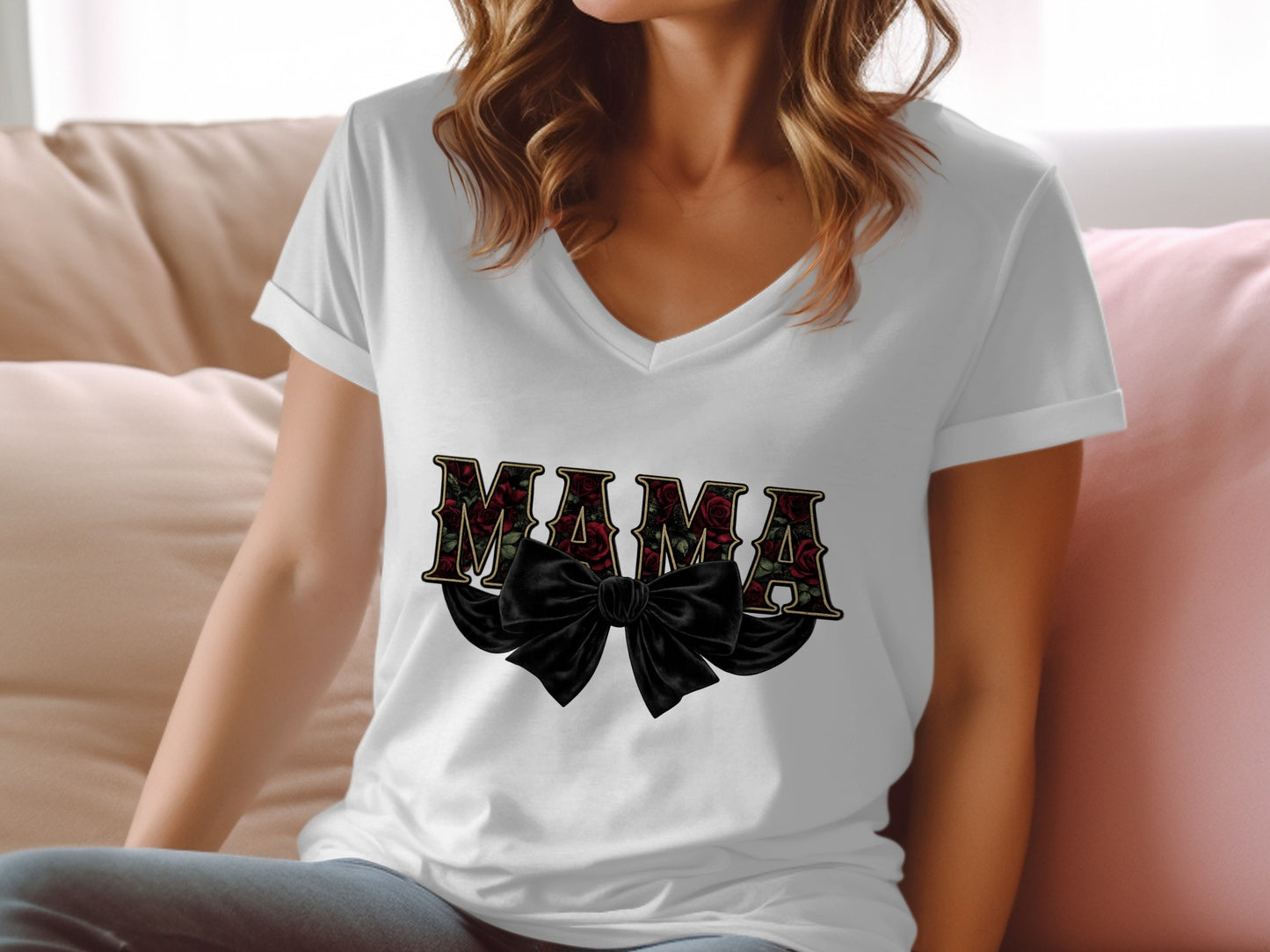 White v-neck t-shirt with black bow and "MAMA" in floral lettering.