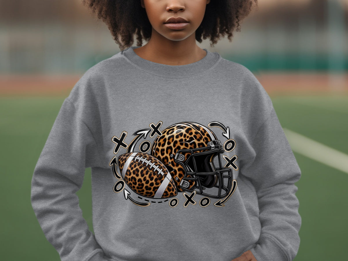 Leopard print football and helmet with Xs and Os and arrows design on gray sweatshirt.