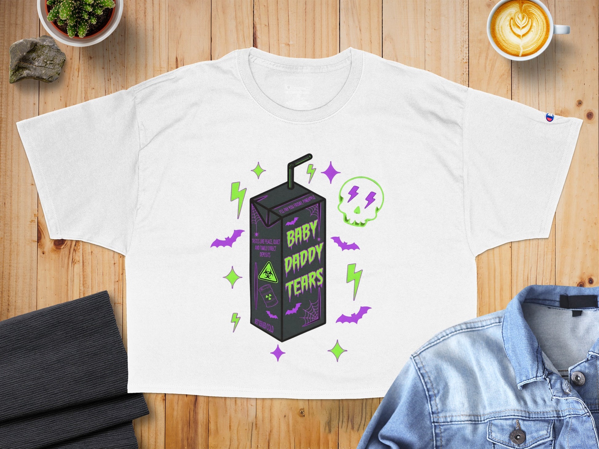 White crop top with "BABY DADDY TEARS" text, lightning bolts, and a juice box graphic.
