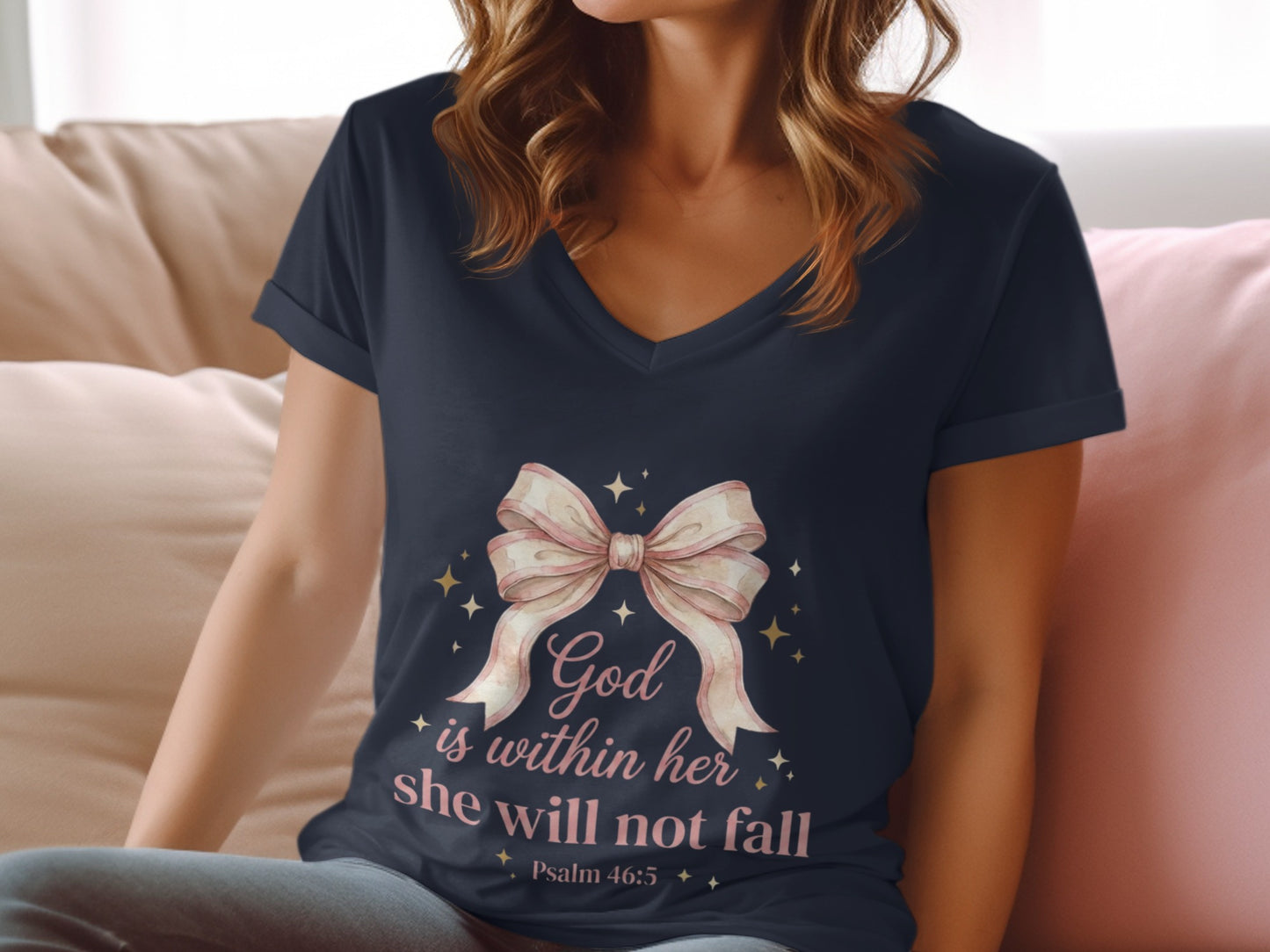 Dark v-neck t-shirt with pink bow and "God is within her she will not fall" text.