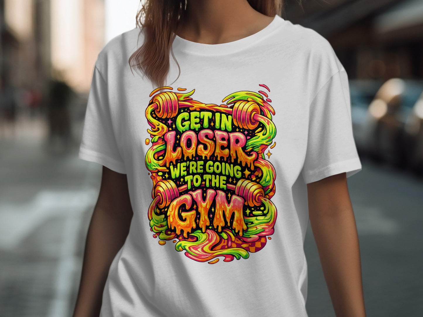 T-shirt with "Get in loser we're going to the gym" text in colorful, dripping font.