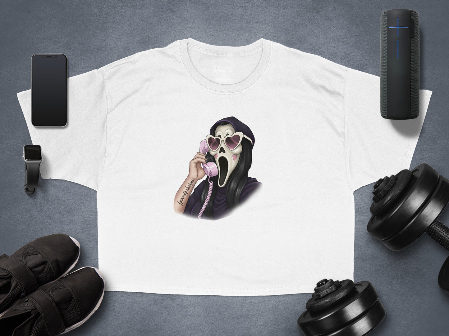 White t-shirt with Grim Reaper on phone, flanked by dumbbells and workout gear.
