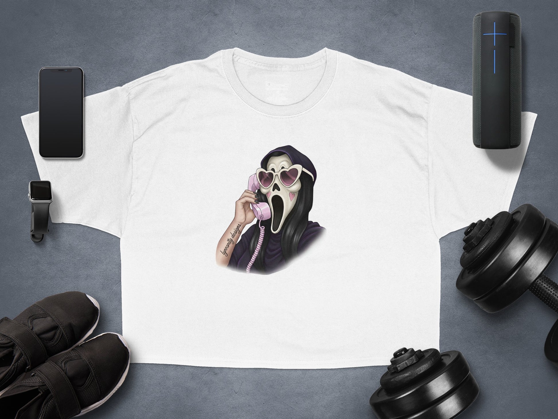 White t-shirt with Grim Reaper on phone, flanked by dumbbells and workout gear.