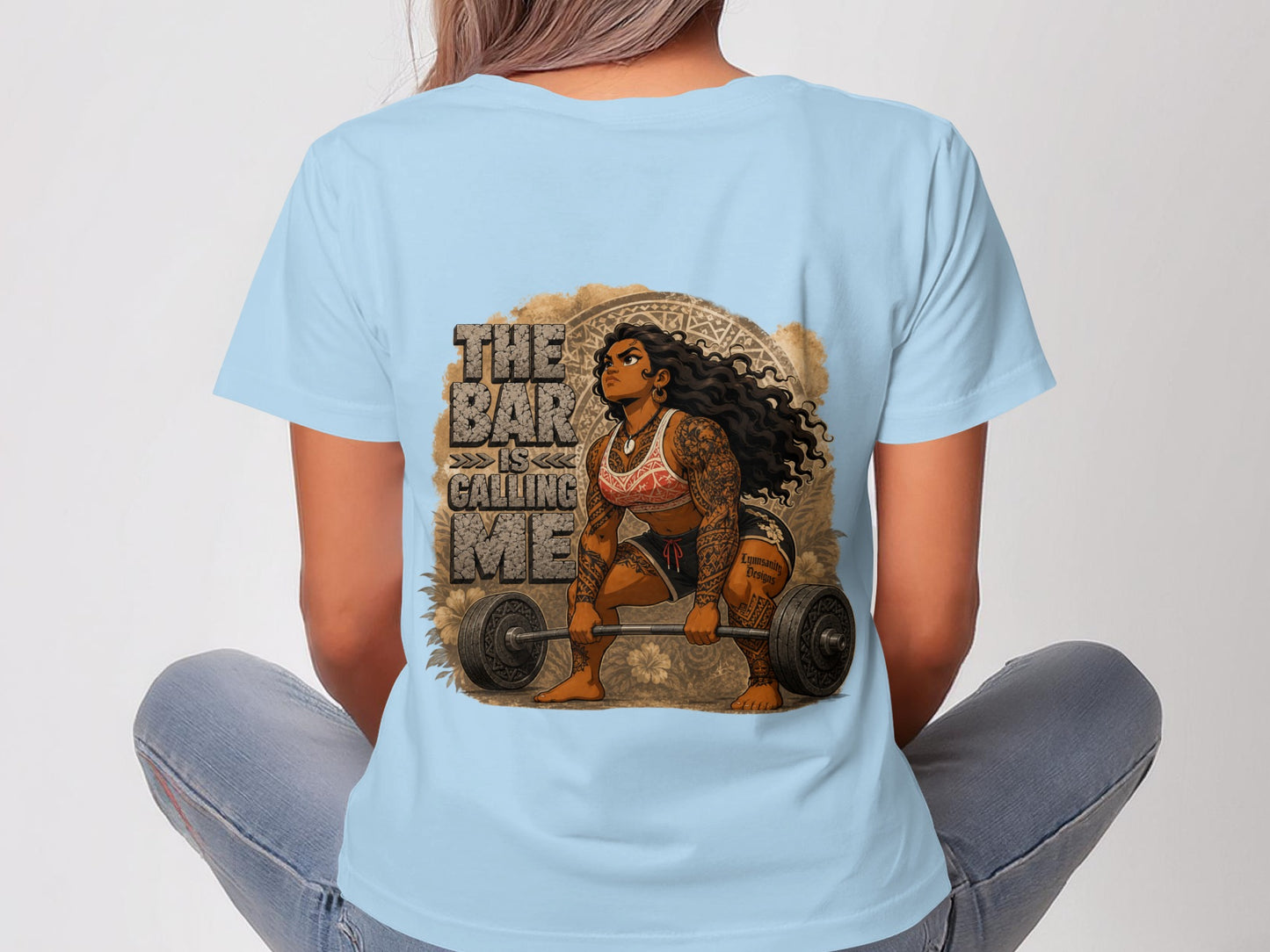 Woman in blue t-shirt with graphic of woman lifting barbell, text "The bar is calling me".