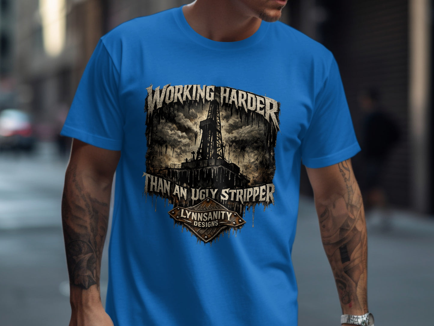Blue t-shirt with "Working Harder Than An Ugly Stripper" text and oil rig graphic.