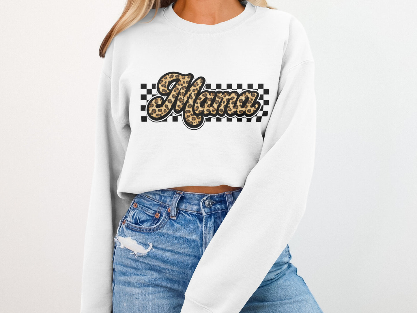 White sweatshirt with "Mama" in leopard print and checkered pattern.