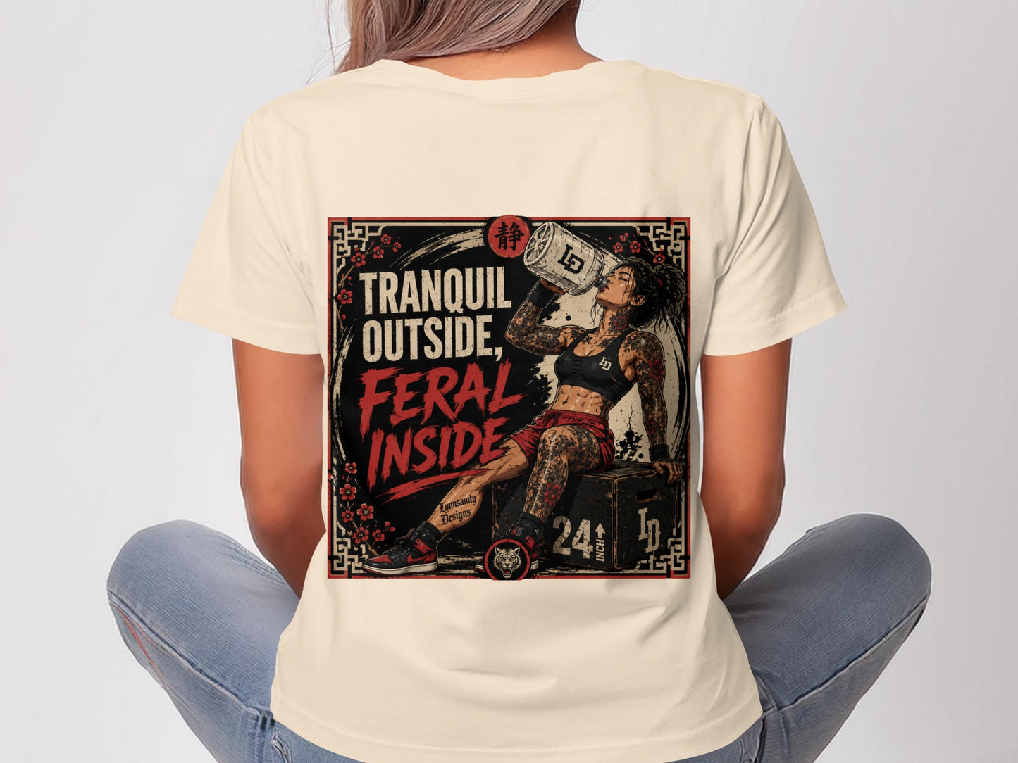Woman wearing a t-shirt with "Tranquil Outside, Feral Inside" text and illustration.