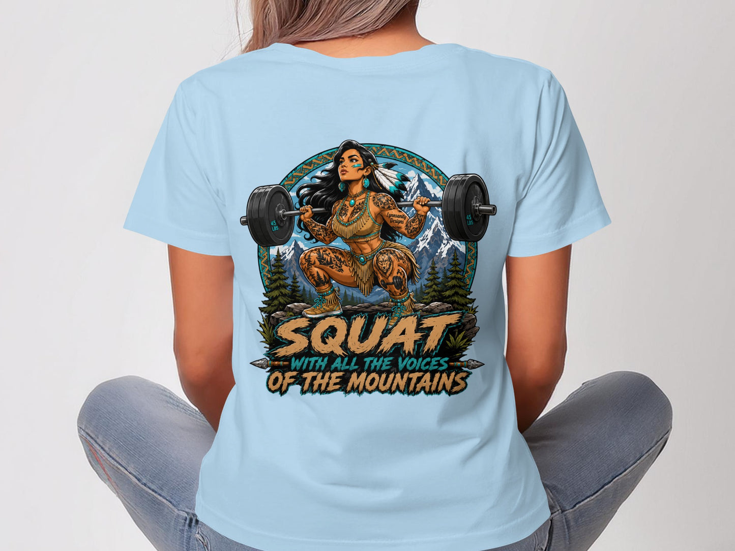 Woman in light blue t-shirt with "Squat with all the voice of the mountains" text.