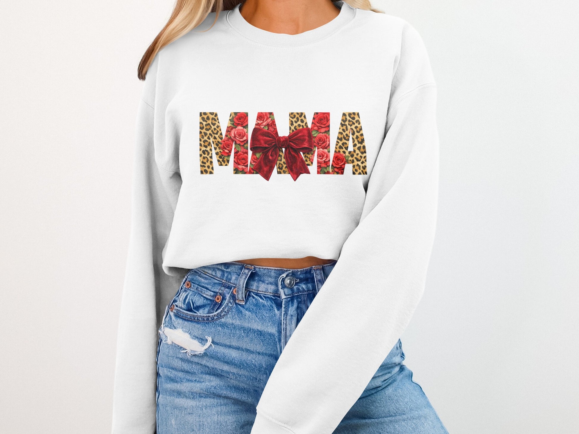 White sweatshirt with "MAMA" design featuring leopard print, roses, and a red bow.