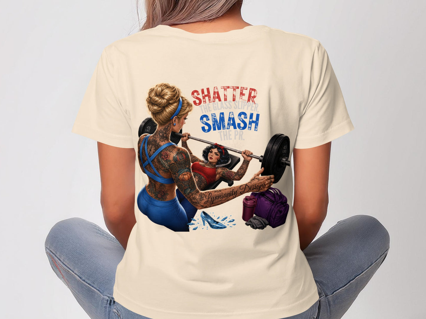 Woman lifting weights wearing shirt that says "SHATTER THE GLASS SLIPPER, SMASH THE PR."