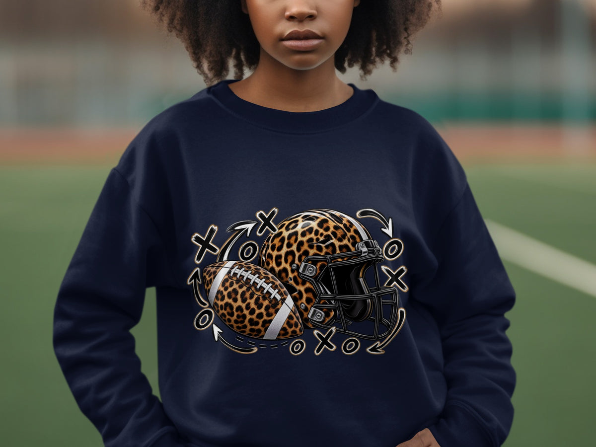 Navy sweatshirt with leopard print football helmet, ball, and Xs and Os graphic.