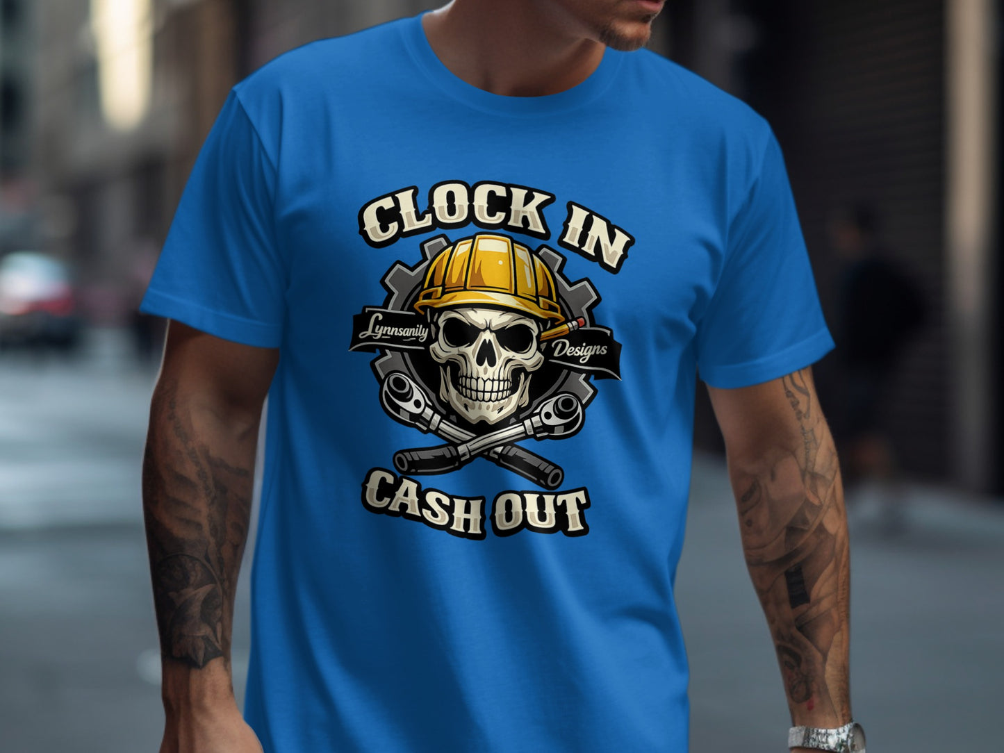 Blue t-shirt with "Clock In Cash Out" text, skull, and tools.