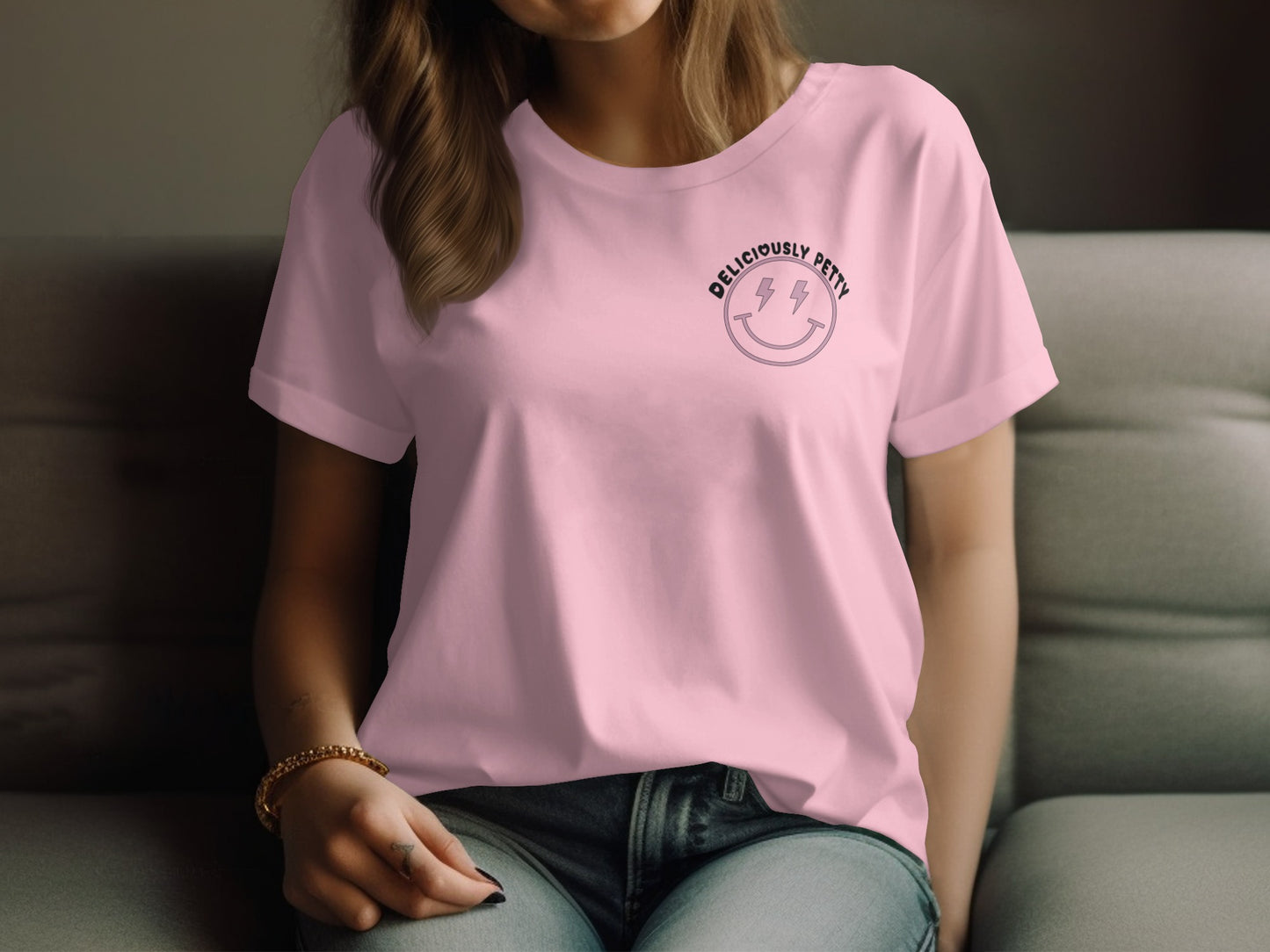Pink t-shirt with black smiley face and lightning bolt graphic.
