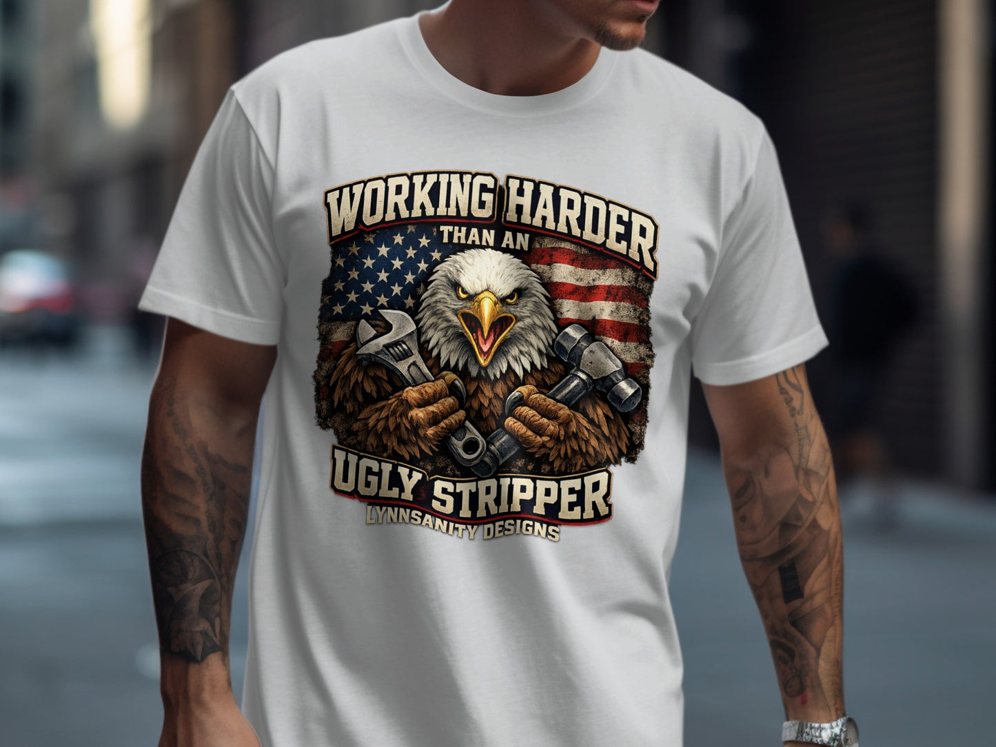 Eagle mechanic holding wrenches in front of American flag, "Working Harder Than An Ugly Stripper" text.