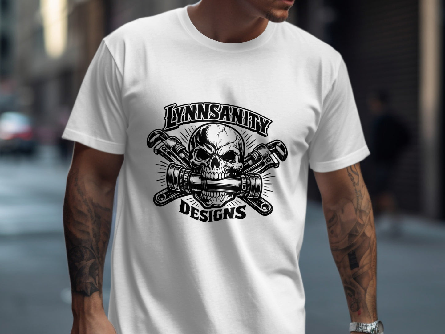 White t-shirt with "LYNNSANITY DESIGNS" and a skull with crossed wrenches graphic.