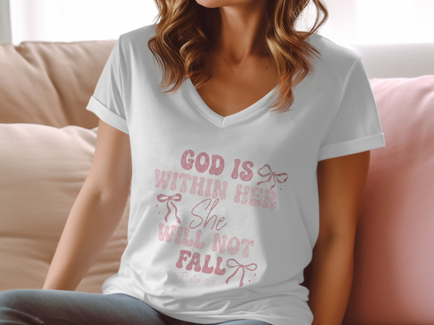 White v-neck t-shirt with pink text "God is Within Her She Will Not Fall".