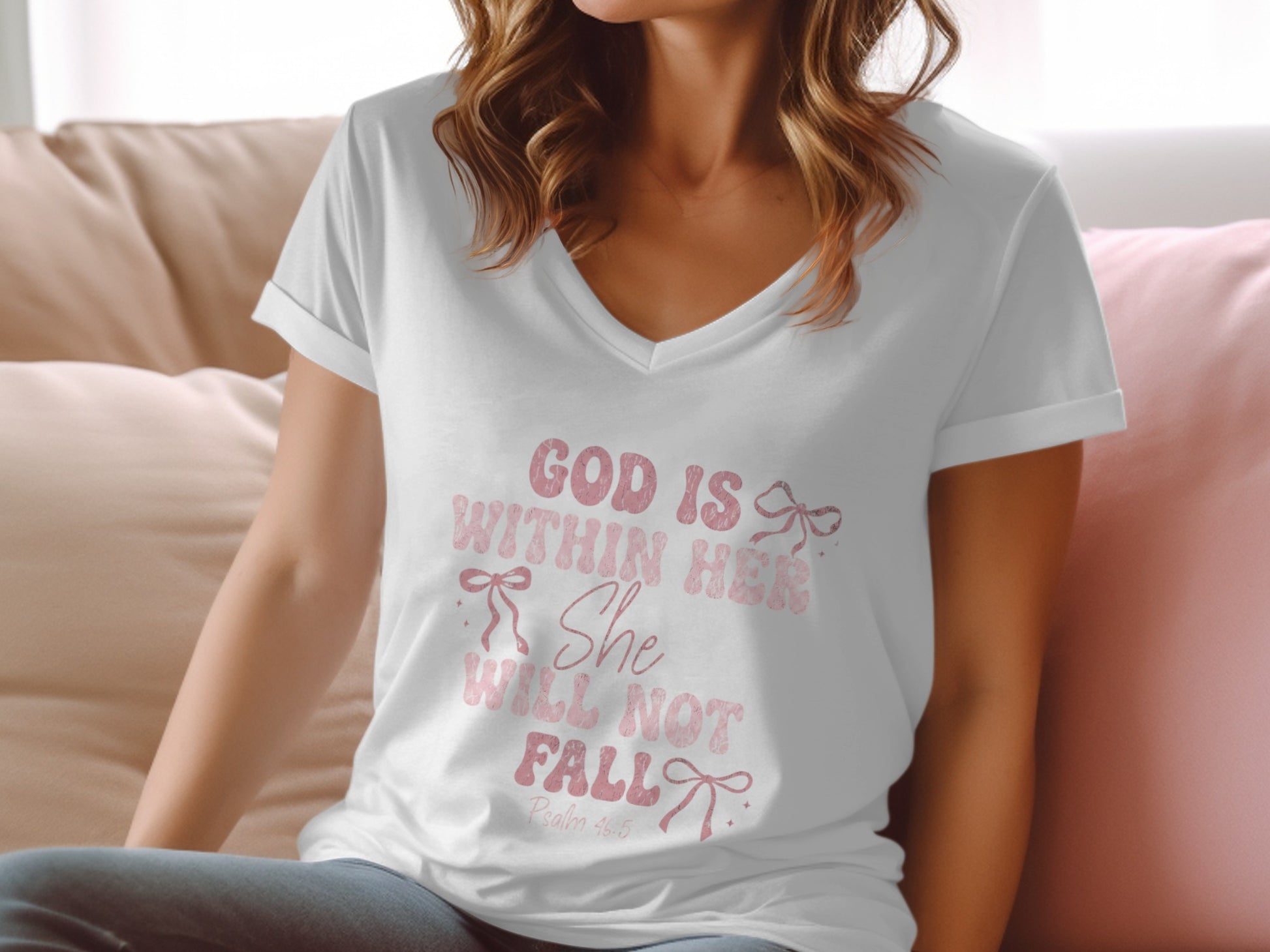 White v-neck t-shirt with pink text "God is Within Her She Will Not Fall".
