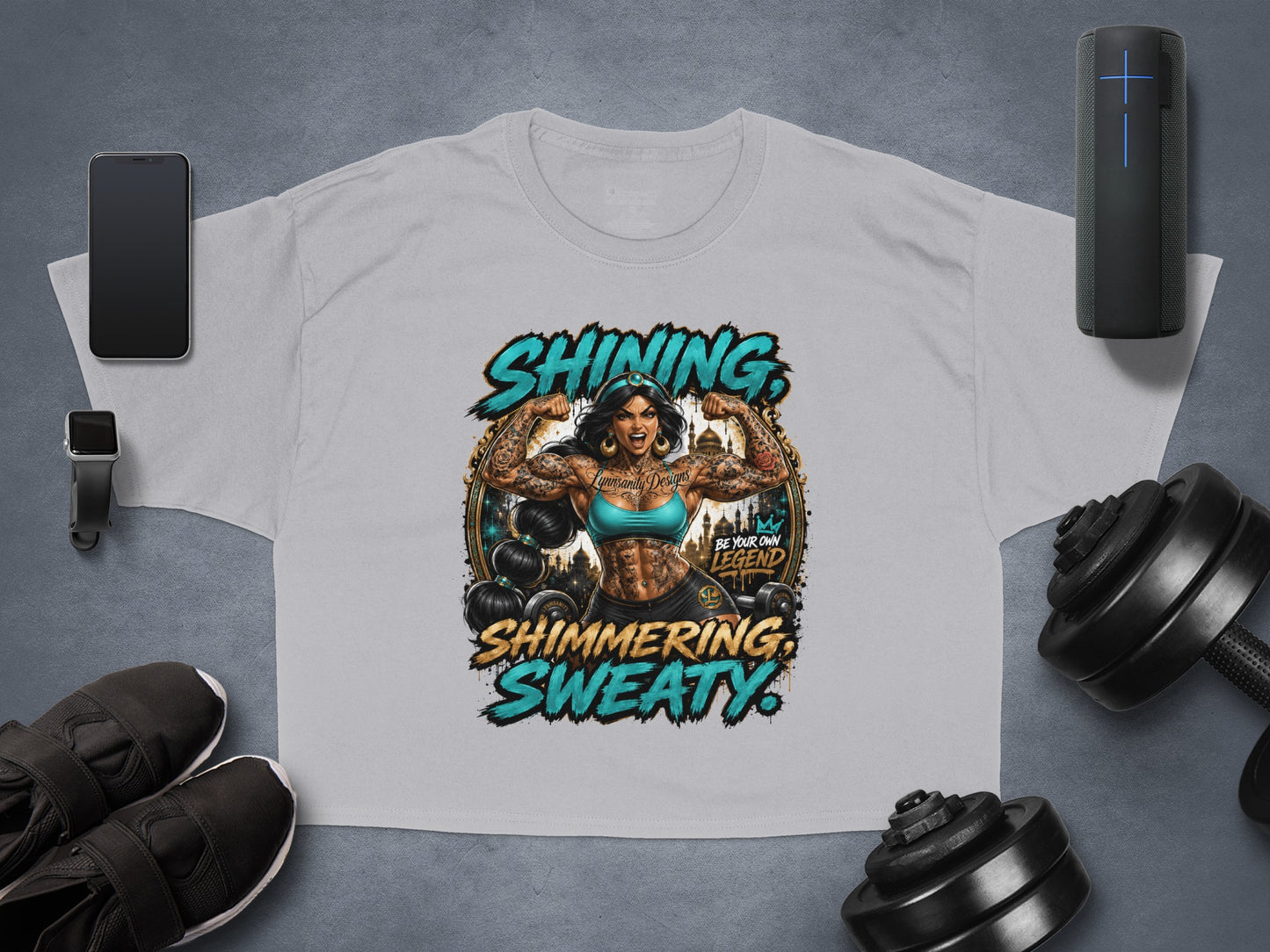 Grey cropped t-shirt with "Shining, Shimmering, Sweaty" text and a muscular female figure.