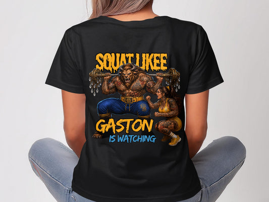 Black t-shirt with "SQUAT LIKE GASTON IS WATCHING" and illustrated characters.