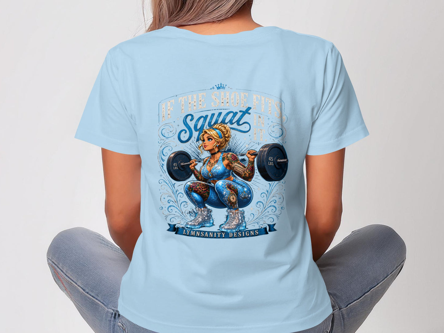 Woman in light blue t-shirt with barbell squat tattoo graphic and text.