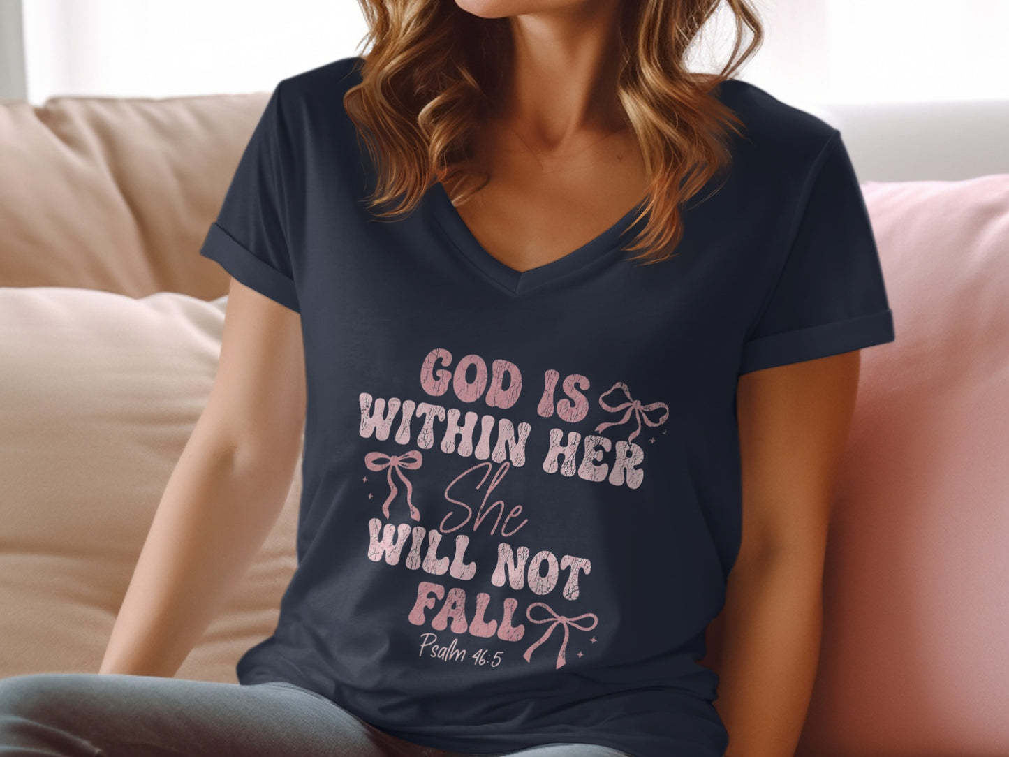 Dark t-shirt with "God is within her" and "She will not fall" text.