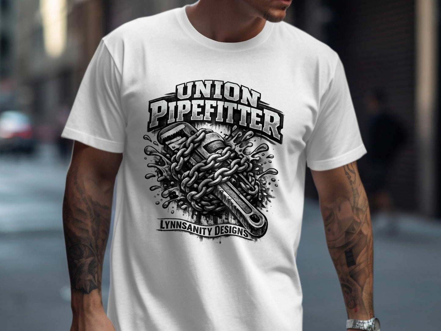 White t-shirt with "Union Pipefitter" text and chained pipe wrench graphic.