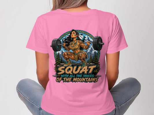 Woman in pink t-shirt with Native American warrior design lifting a barbell.