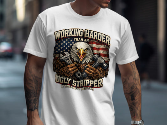 T-shirt graphic of eagle holding tools with American flag and text.