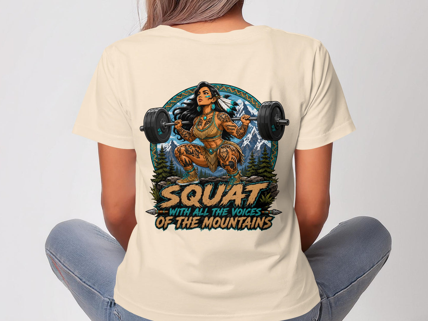 Woman in cream t-shirt with Native American-inspired graphic of a woman squatting with a barbell.