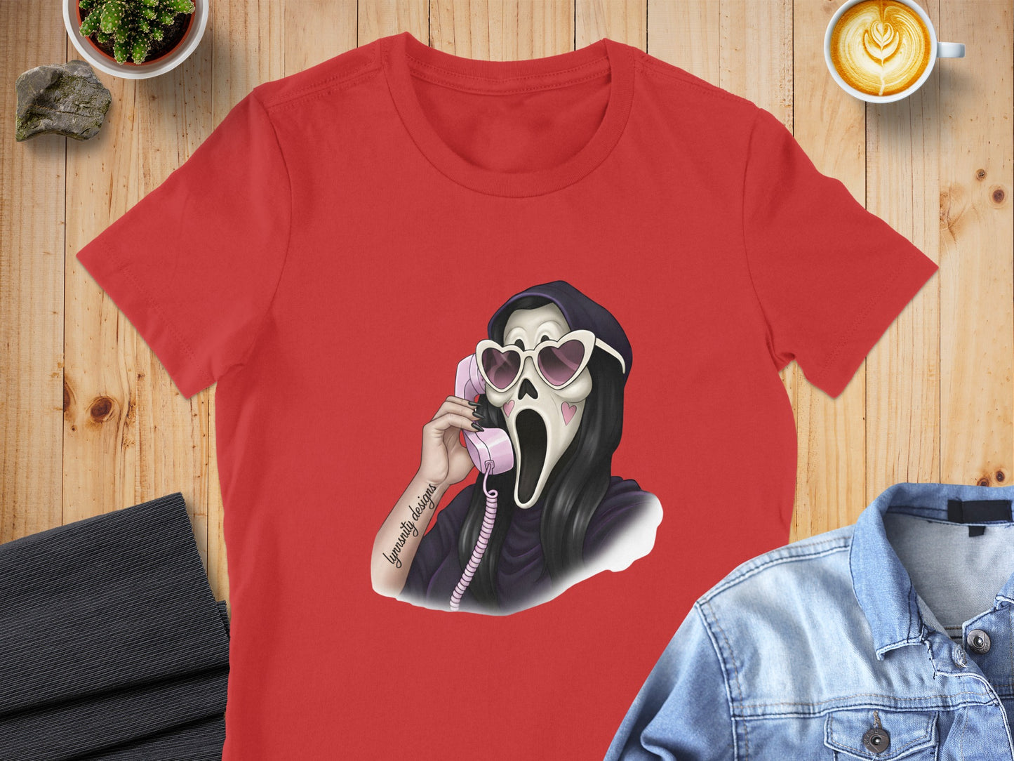 Red t-shirt featuring a ghost wearing heart sunglasses talking on a pink phone.