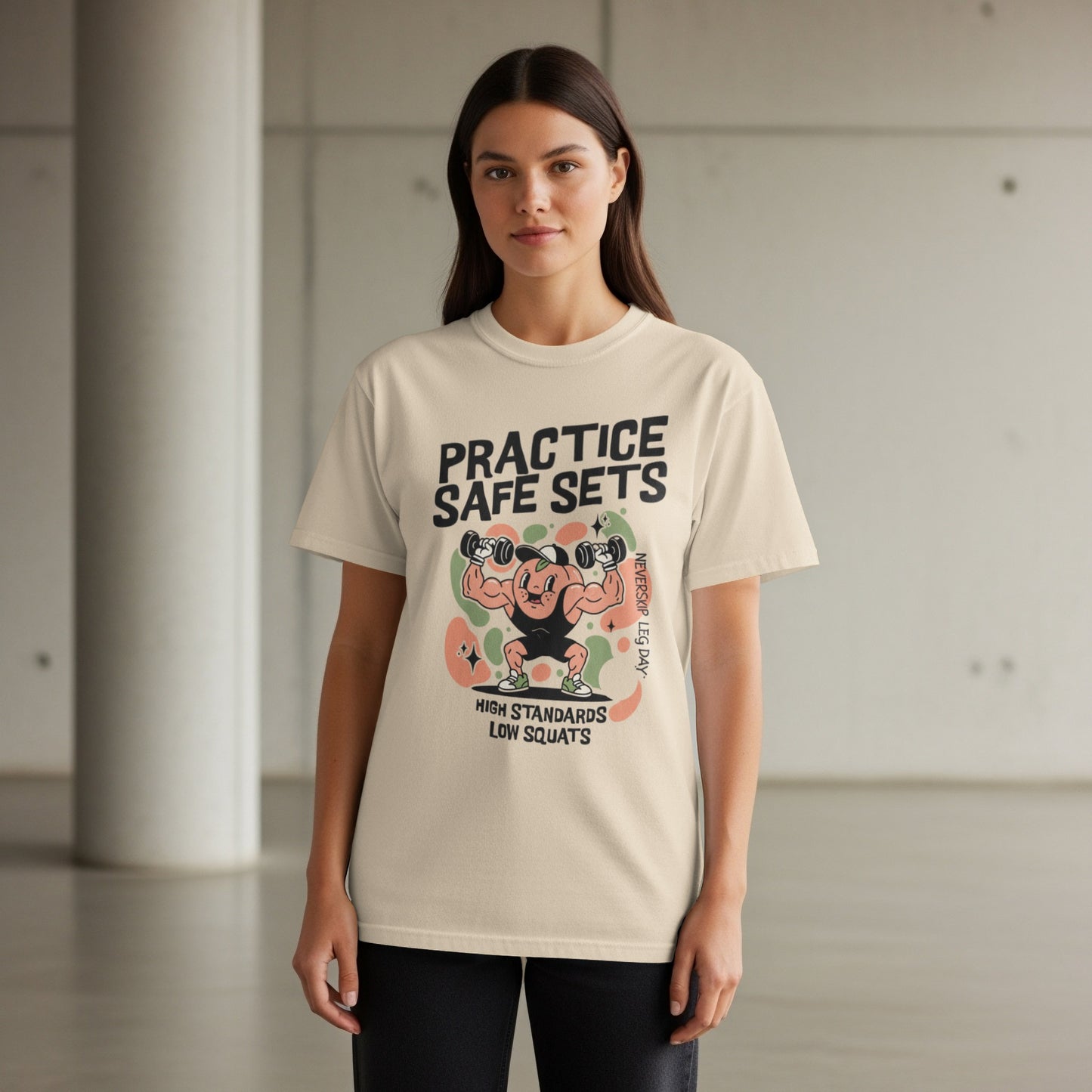 Cream t-shirt with cartoon weightlifter graphic and text "PRACTICE SAFE SETS".